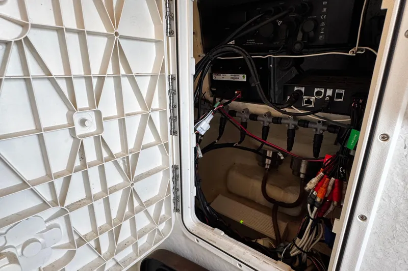 Slide: The Image of Electrical panel inside a 2015 Sailfish 320 CC boat, showcasing wiring and components. - 54