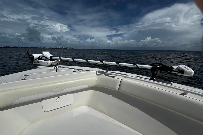 Slide: The Image of 2015 Sailfish 320 CC boat on open water under cloudy sky. - 58