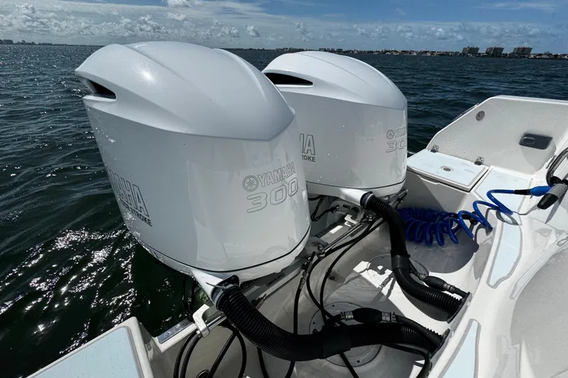 Slide: The Image of Twin Yamaha 300 outboard engines on a 2015 Sailfish 320 CC boat in open water. - 59