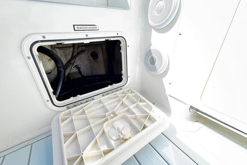 Slide: The Image of Seacock access panel on 2015 Sailfish 320 CC boat, featuring interior components and speakers. - 60