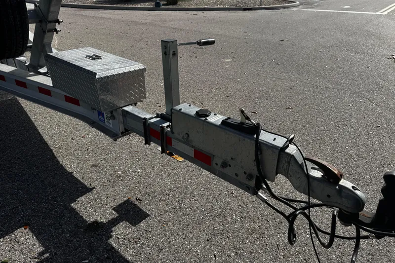 Slide: The Image of Trailer hitch of a 2015 Sailfish 320 CC boat on asphalt road. - 9