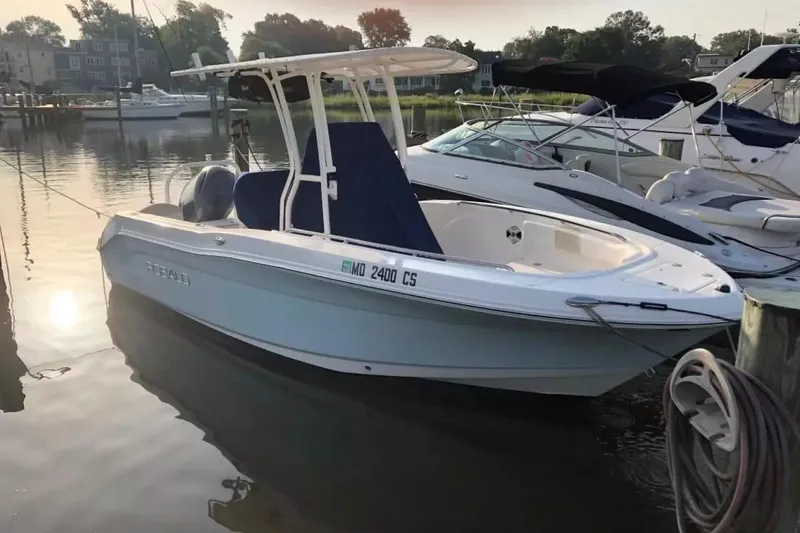The Image of 2016 Robalo R200 Center Console boat docked in a serene marina setting. - 0