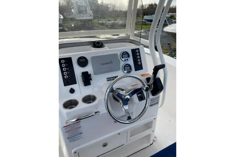 Slide: The Image of 2016 Robalo R200 Center Console dashboard with Garmin navigation system and steering wheel. - 5