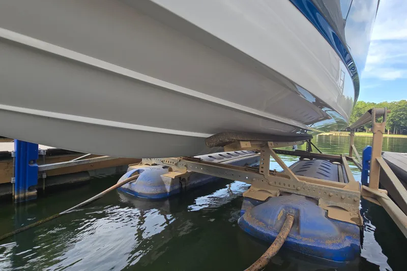 Slide: The Image of 2021 Cobalt R5 boat on a lift, docked by a serene lake. - 10