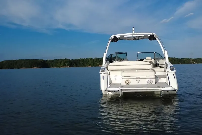 Slide: The Image of 2021 Cobalt R5 boat on calm lake with clear blue sky. - 14