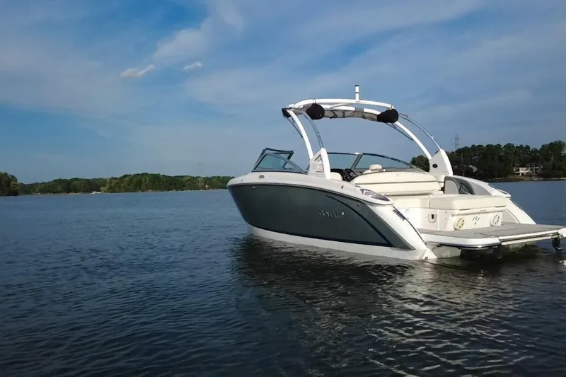 Slide: The Image of 2021 Cobalt R5 boat on a serene lake under a clear blue sky. - 15
