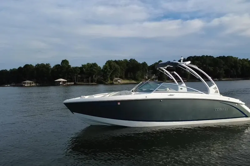 Slide: The Image of 2021 Cobalt R5 boat on a serene lake with wooded shoreline. - 17