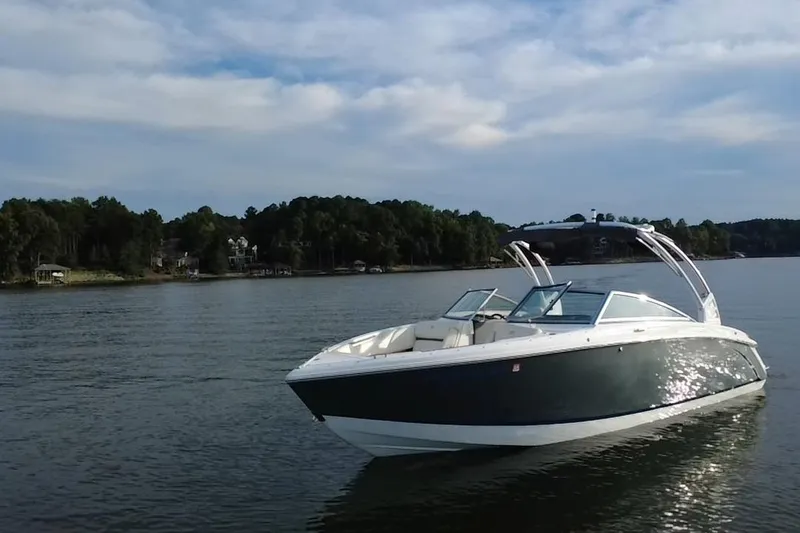 Slide: The Image of 2021 Cobalt R5 boat on a serene lake with wooded shoreline. - 18