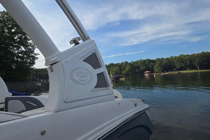 Slide: The Image of 2021 Cobalt R5 boat on a serene lake with lush green shoreline. - 23