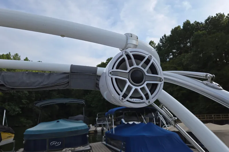 Slide: The Image of Boat speaker on a 2021 Cobalt R5, docked with other boats in the background. - 24