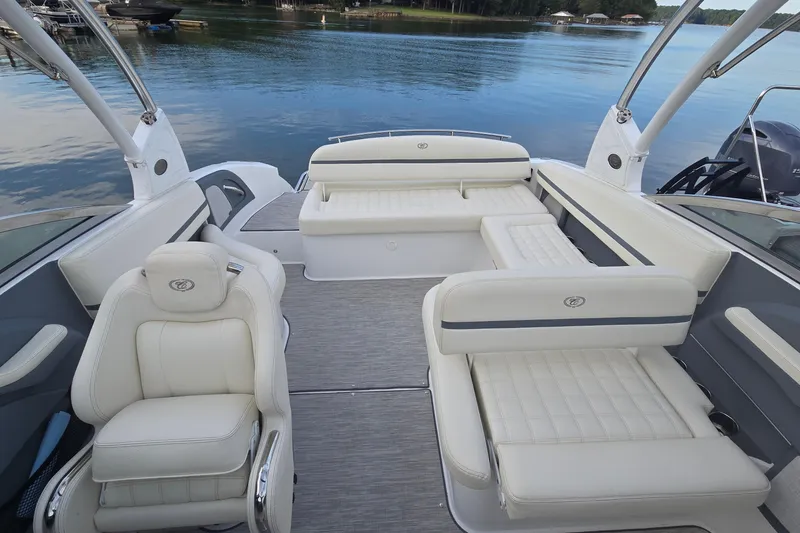 Slide: The Image of 2021 Cobalt R5 boat interior with luxurious white seating on a calm lake. - 25