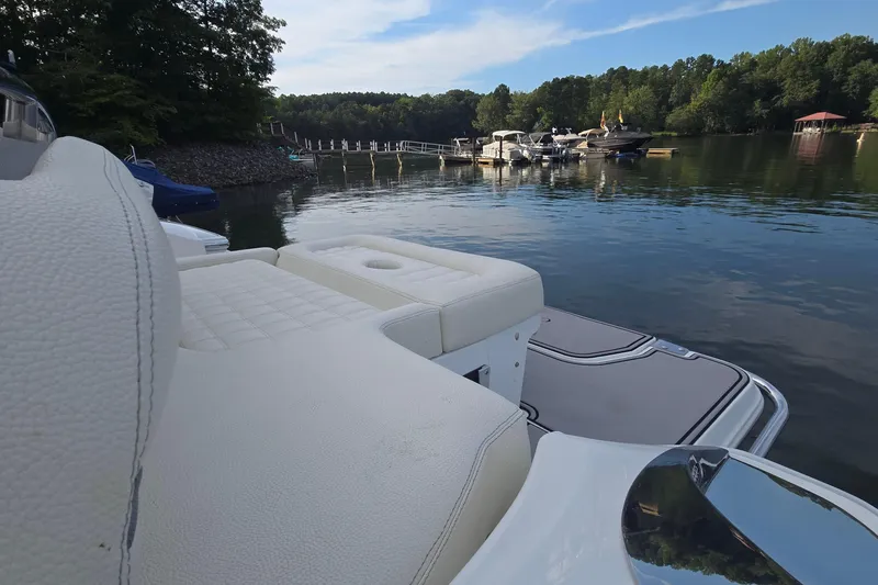 Slide: The Image of 2021 Cobalt R5 boat with white seating, docked on a serene lake. - 27