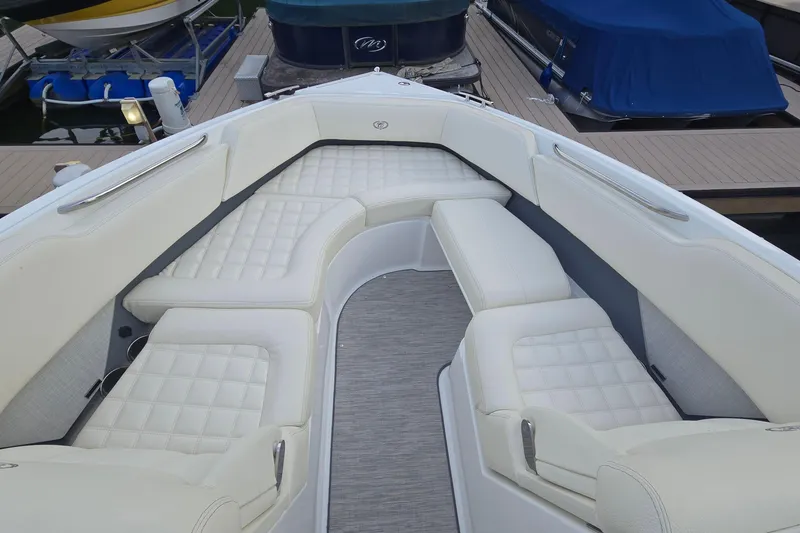 Slide: The Image of 2021 Cobalt R5 boat interior with white cushioned seating at a dock. - 28