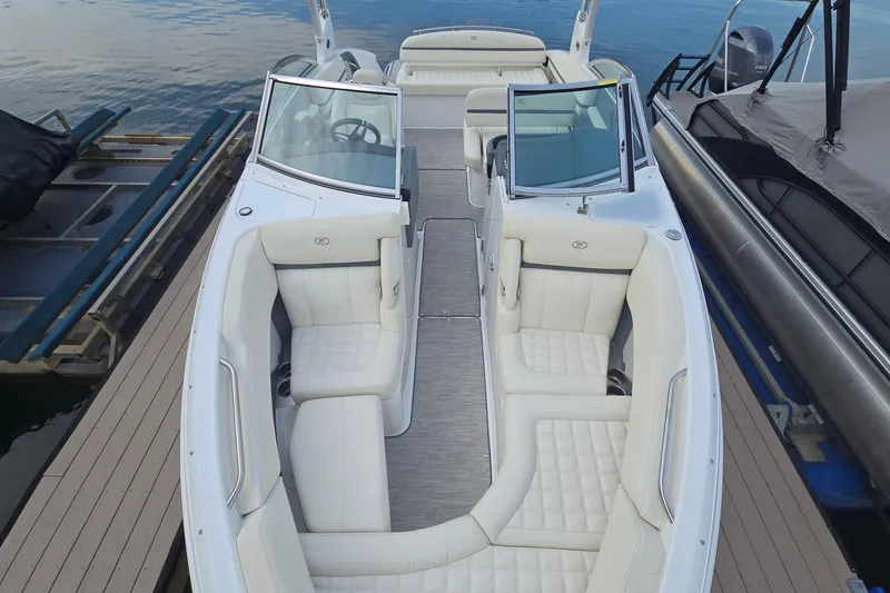 Slide: The Image of 2021 Cobalt R5 boat with luxurious white seating docked by the water. - 29