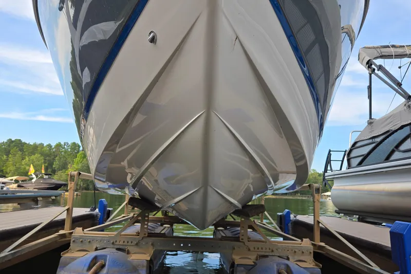 Slide: The Image of 2021 Cobalt R5 boat on trailer at marina, surrounded by water and trees. - 3