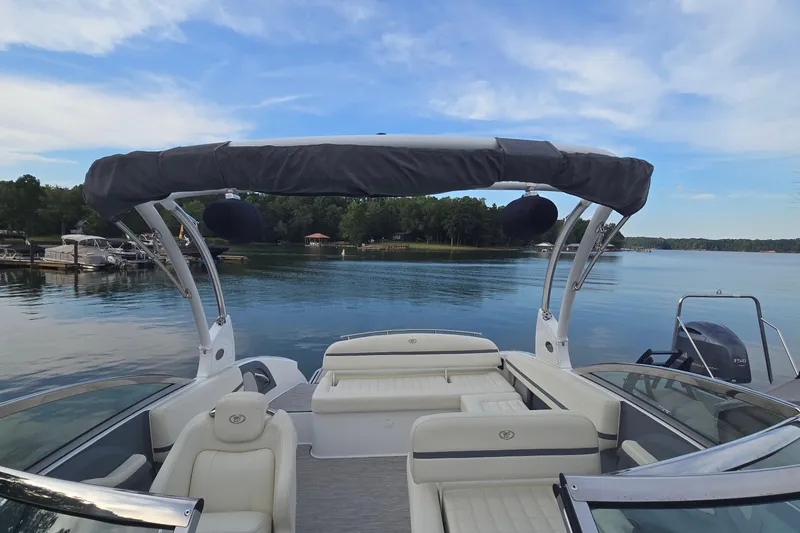 Slide: The Image of 2021 Cobalt R5 boat on a serene lake with a clear blue sky. - 30