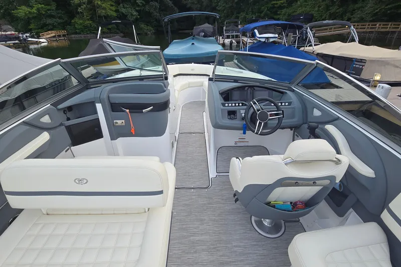 Slide: The Image of 2021 Cobalt R5 boat interior with sleek design and modern dashboard at a marina. - 32