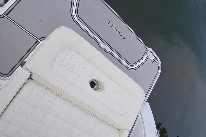 Slide: The Image of 2021 Cobalt R5 boat with white cushioned seating and sleek deck design. - 33