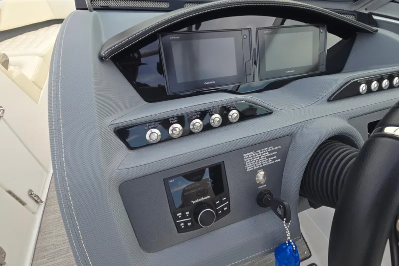 Slide: The Image of 2021 Cobalt R5 boat dashboard with Garmin displays and control panel. - 38