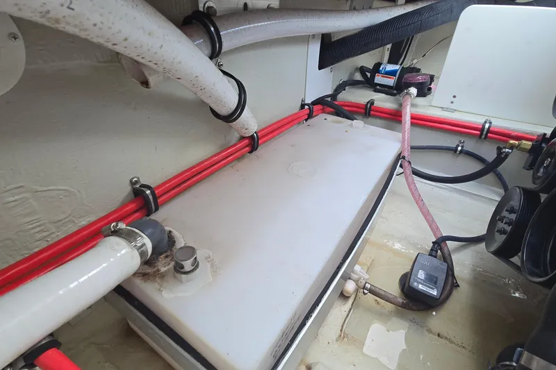 Slide: The Image of 2021 Cobalt R5 boat interior showing plumbing and wiring components. - 44