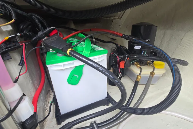 Slide: The Image of 2021 Cobalt R5 boat battery compartment with wiring and components. - 45