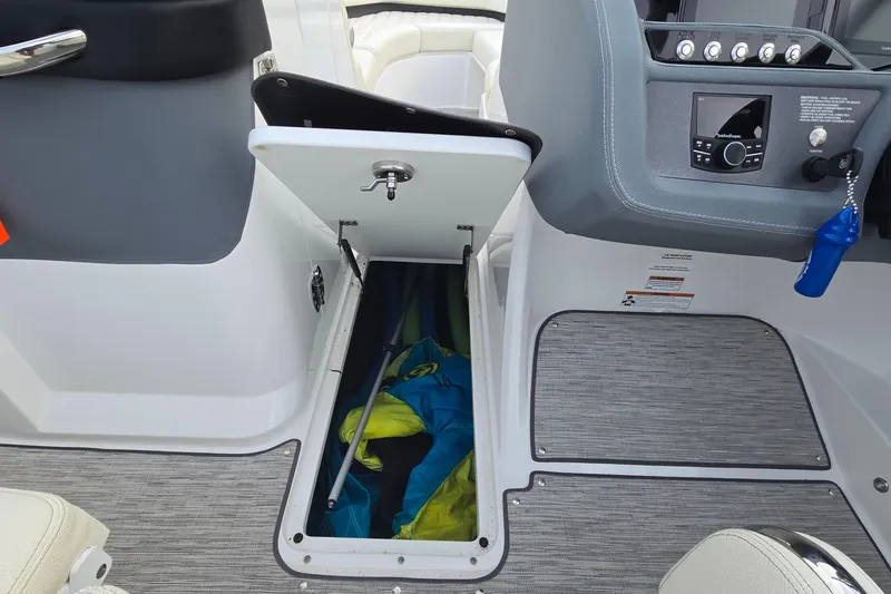 Slide: The Image of 2021 Cobalt R5 boat interior with open storage compartment and visible gear. - 47