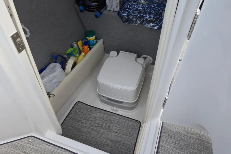 Slide: The Image of 2021 Cobalt R5 boat interior with portable toilet and storage area. - 51