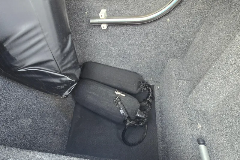 Slide: The Image of 2021 Cobalt R5 boat storage compartment with black fenders and metal railing. - 54