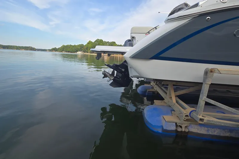 Slide: The Image of 2021 Cobalt R5 boat on lift by serene lake with clear sky. - 9