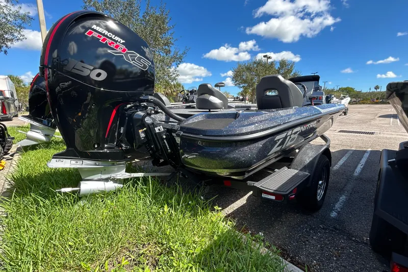 Slide: The Image of 2026 Nitro Z18 Pro boat with Mercury Pro XS engine in a sunny parking lot. - 3