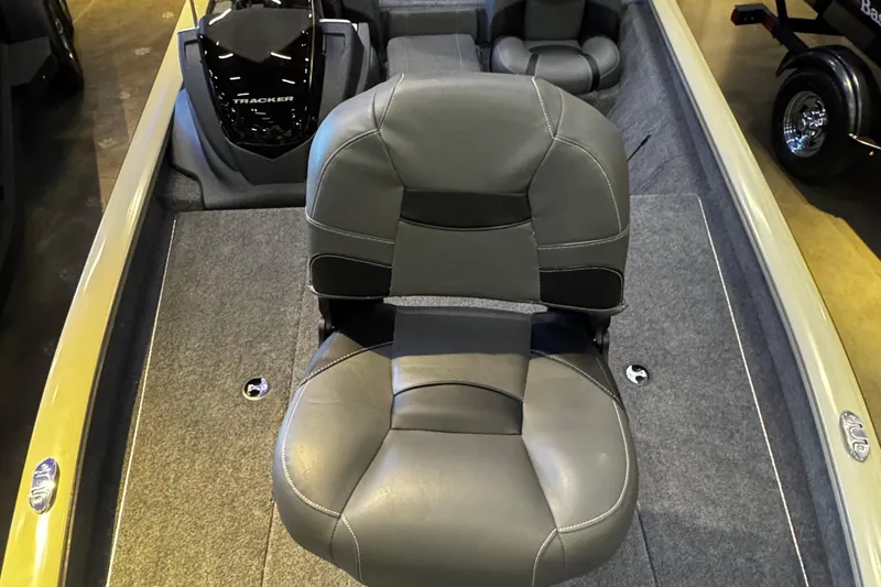 Slide: The Image of 2026 Tracker Pro Team 190 boat interior with gray seating and carpeted deck. - 2