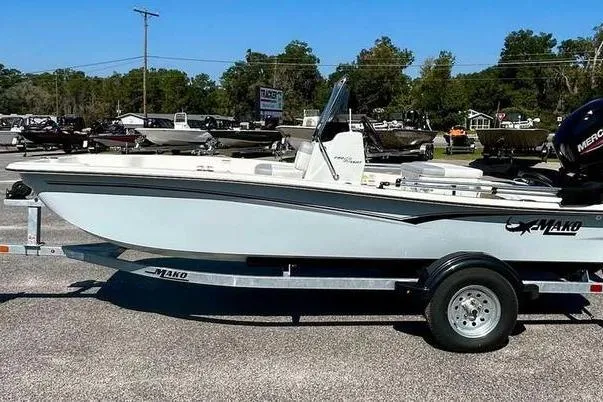 The Image of 2026 Mako Pro Skiff 15 CC boat on trailer in outdoor dealership lot. - 0