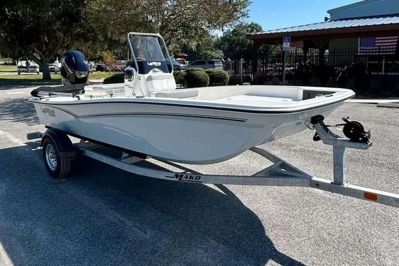 Slide: The Image of 2026 Mako Pro Skiff 15 CC boat on trailer in sunny outdoor setting. - 3