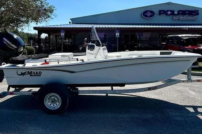Slide: The Image of 2026 Mako Pro Skiff 15 CC boat on trailer outside dealership. - 4