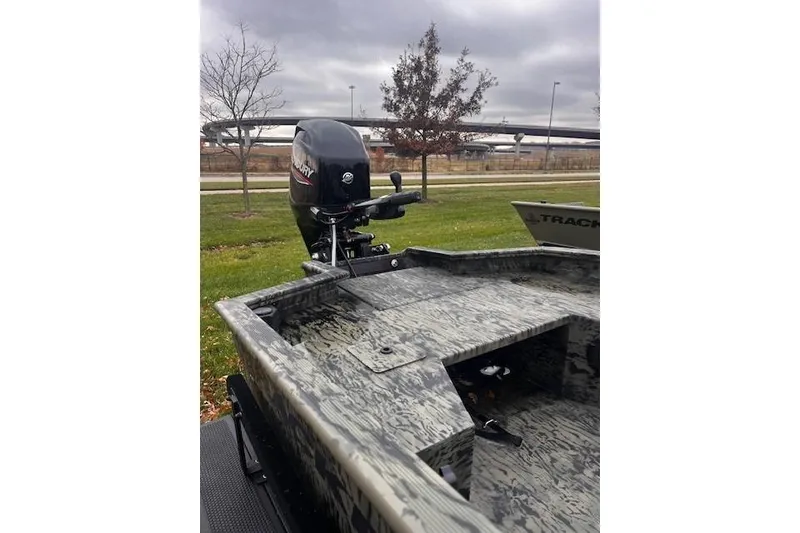 Slide: The Image of 2026 Tracker Grizzly 1650 T Prairie Wings Edition boat with camo design and outboard motor. - 34