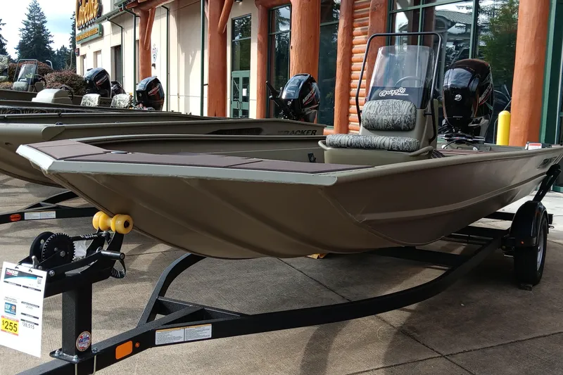 The Image of 2026 Tracker Grizzly 1860 CC boat displayed outdoors on a trailer. - 0
