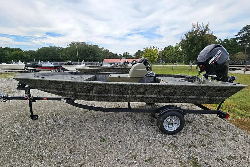 The Image of 2026 Tracker Grizzly 1648 SC boat on trailer, featuring a Mercury outboard motor. - 1