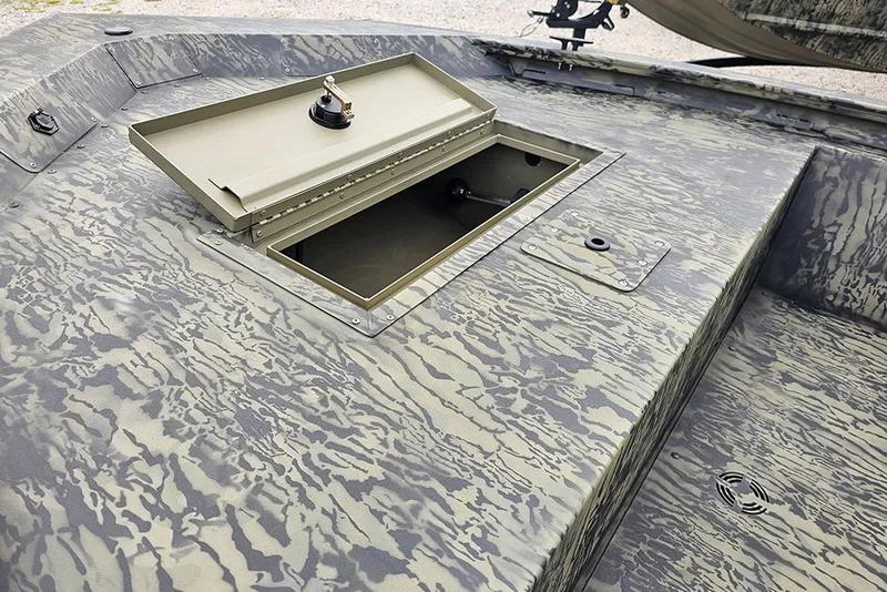 Slide: The Image of 2026 Tracker Grizzly 1648 SC boat with open storage compartment, camo pattern design. - 12