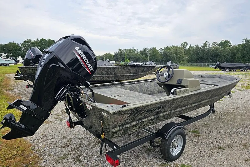 Slide: The Image of 2026 Tracker Grizzly 1648 SC boat with Mercury outboard motor on a trailer. - 7