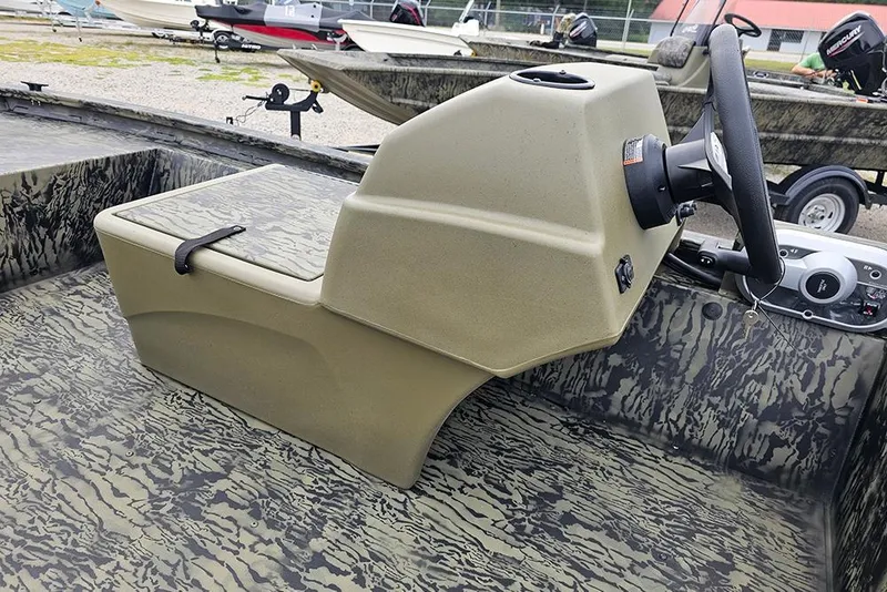 Slide: The Image of 2026 Tracker Grizzly 1648 SC boat interior with steering console and camouflage design. - 9