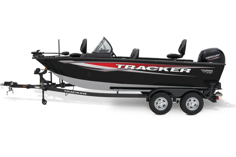 Slide: The Image of 2026 Tracker Targa V-18 WT boat in showroom, black exterior, on trailer. - 2