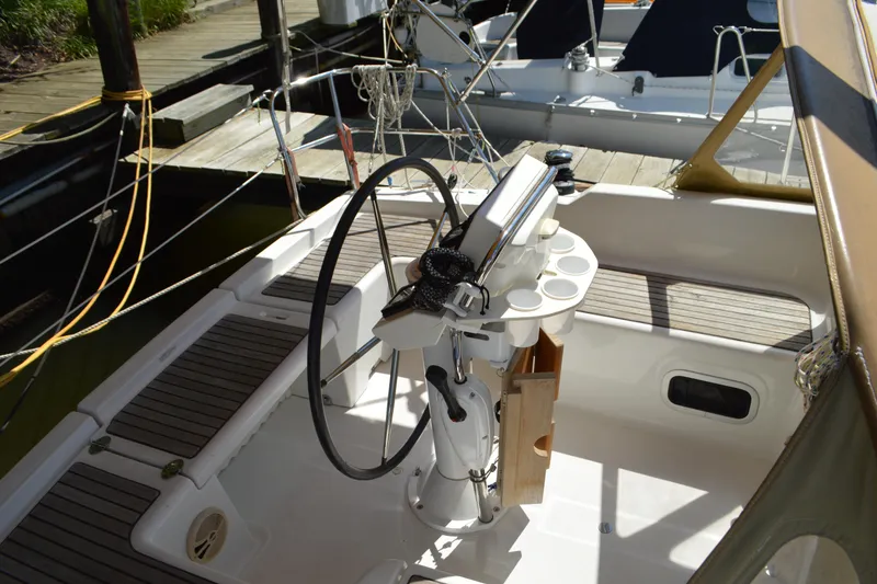 Slide: The Image of Cockpit of 2012 Beneteau Oceanis 34 sailboat with steering wheel and seating. - 11