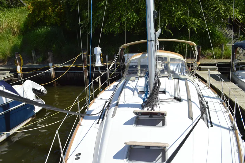 Slide: The Image of 2012 Beneteau Oceanis 34 sailboat docked, featuring sleek design and modern rigging. - 16