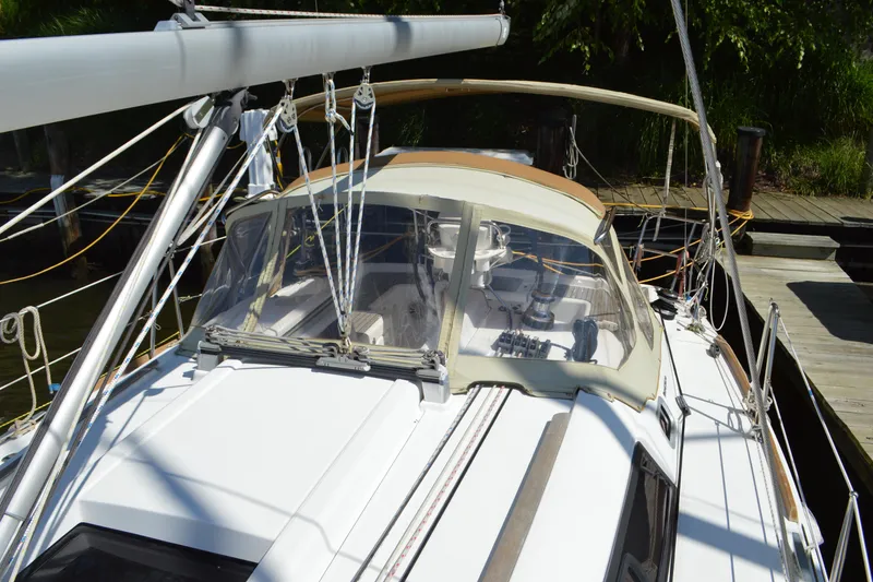 Slide: The Image of 2012 Beneteau Oceanis 34 sailboat docked, featuring a sleek design and spacious cockpit. - 17