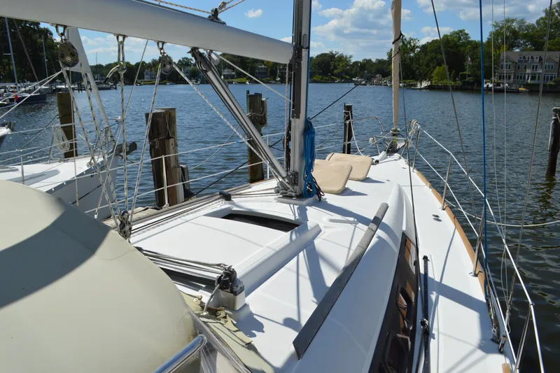 Slide: The Image of 2012 Beneteau Oceanis 34 sailboat docked on a sunny day, showcasing deck and rigging. - 19