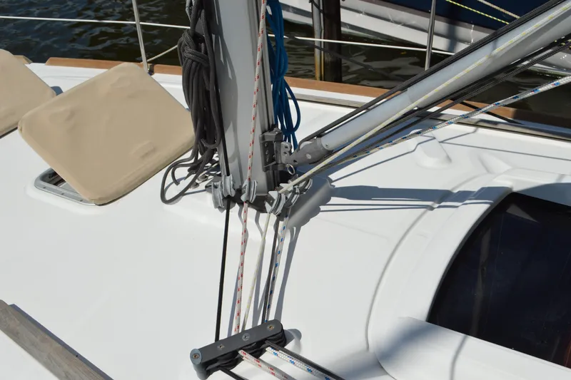 Slide: The Image of Deck view of 2012 Beneteau Oceanis 34 sailboat with rigging and beige cushions. - 23