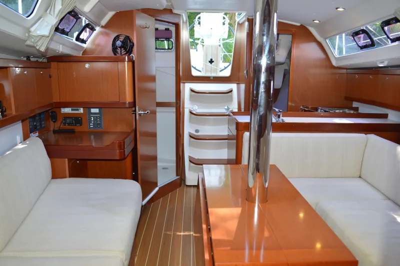 Slide: The Image of Interior of 2012 Beneteau Oceanis 34 sailboat with wood finish and seating area. - 33