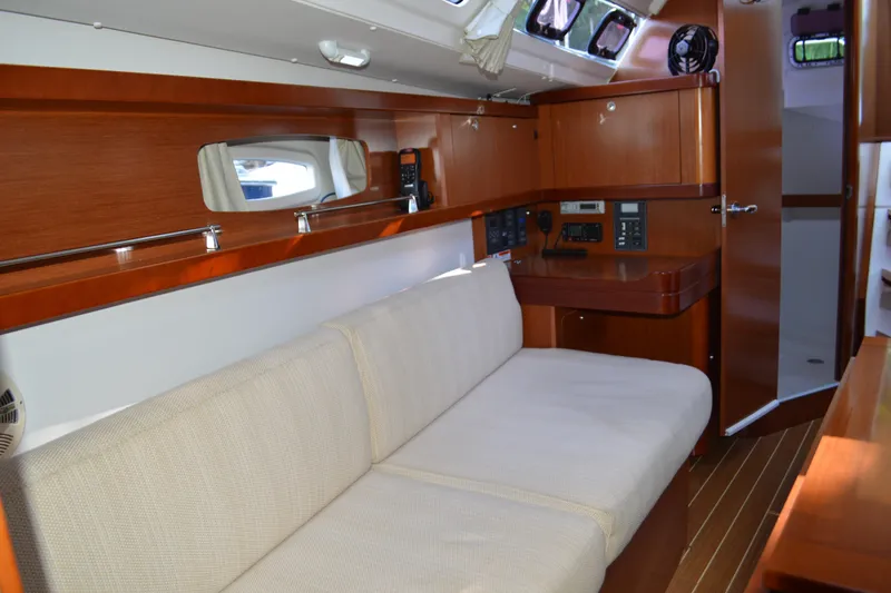 Slide: The Image of Interior of 2012 Beneteau Oceanis 34 yacht with wooden cabinetry and beige seating. - 37