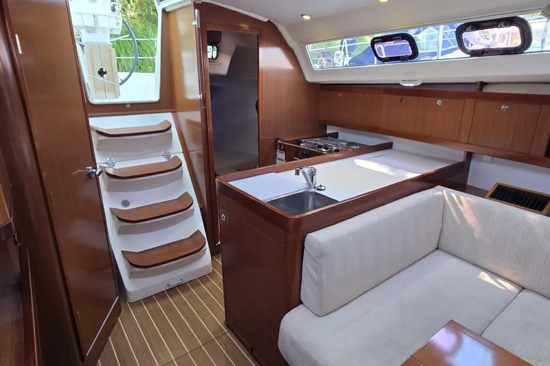 Slide: The Image of Interior of 2012 Beneteau Oceanis 34 sailboat with modern kitchen and seating area. - 39