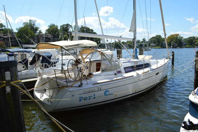 Slide: The Image of 2012 Beneteau Oceanis 34 sailboat docked in a marina on a sunny day. - 4